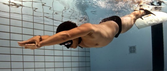 Freediver underwater diving with monofin during freediving competition in London UK