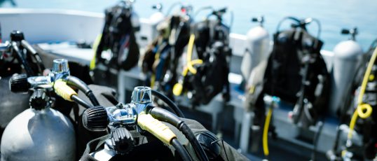 Close-up of underwater diving equipments on boat.
